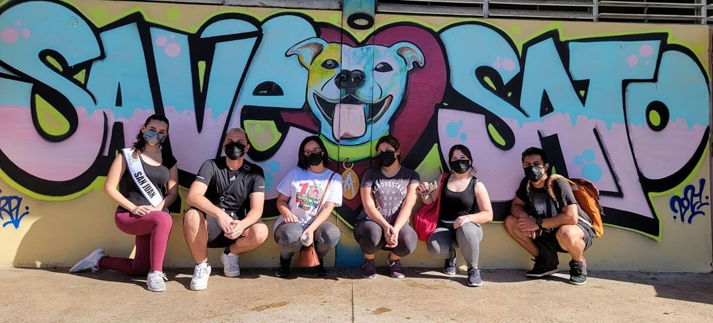 Save A Sato volunteers in front of the shelter mural in San Juan